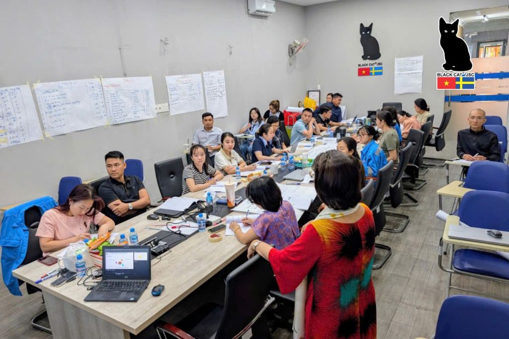 A focused and engaging atmosphere during the internal training session on applying KPIs in work performance evaluation.